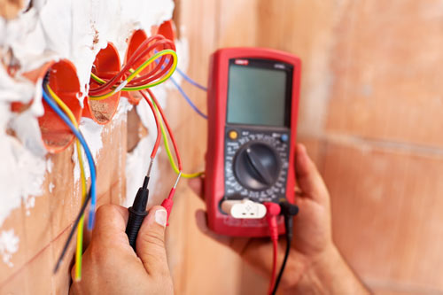 Photograph of electrician testing sockets